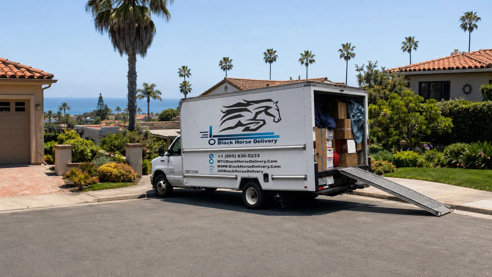 A Black Horse Delivery moving truck on a narrow Mesa street with ocean views in Santa Barbara