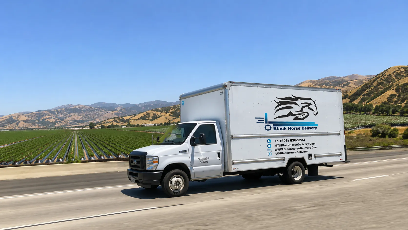 A Black Horse Delivery truck on Highway 101 between Oxnard and Camarillo with farmland and hills