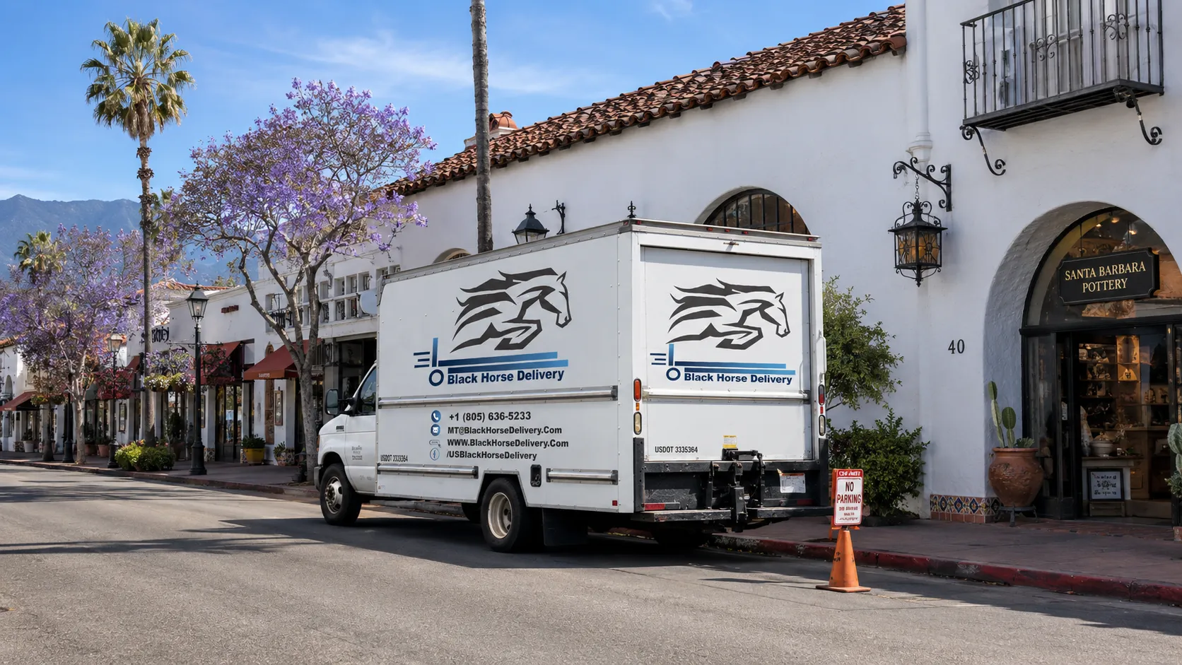 A moving truck parked with a temporary no-parking permit sign on a narrow downtown Santa Barbara street